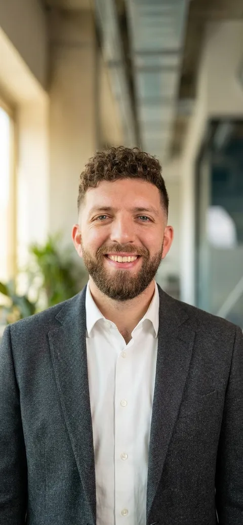 Daniel Petro smiling in a suit